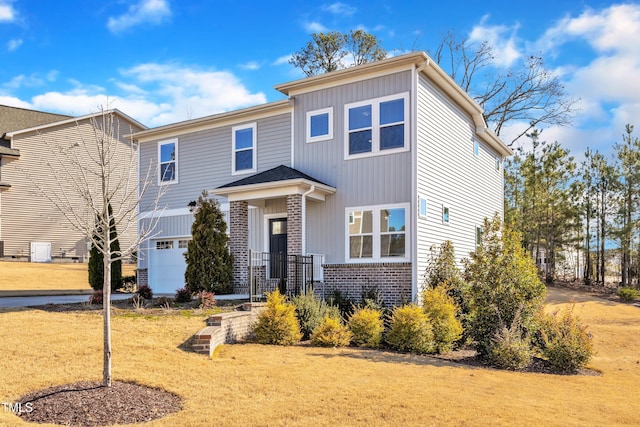 view of front of home featuring a front yard and a garage