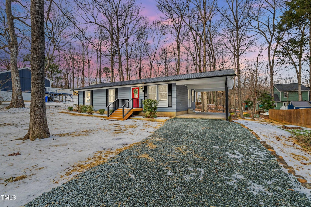 view of front of property featuring a carport