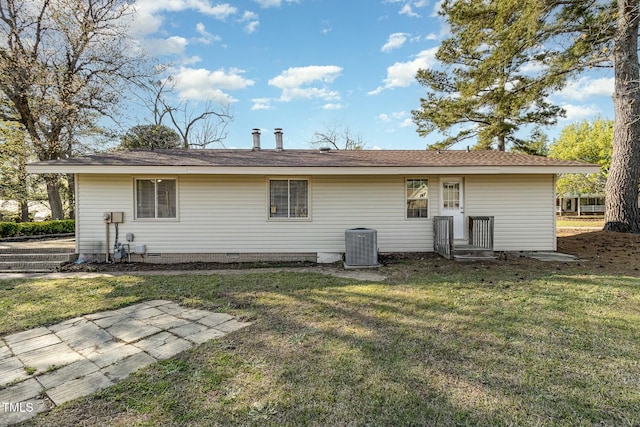 back of property with cooling unit and a lawn