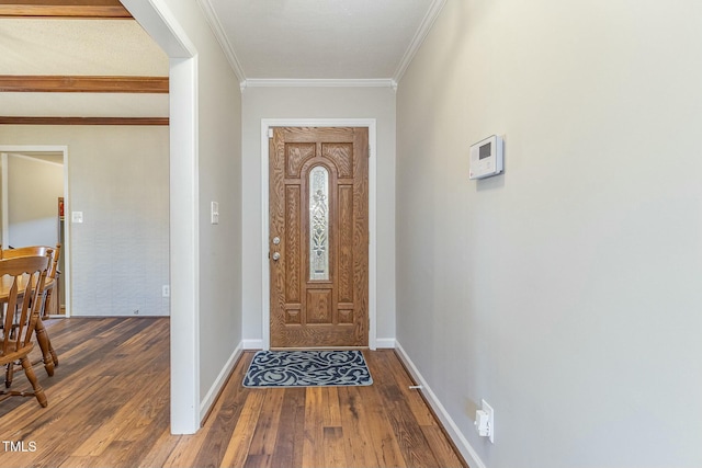 foyer entrance featuring hardwood / wood-style floors and crown molding