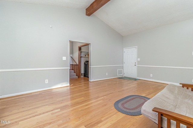 living room featuring light hardwood / wood-style flooring and lofted ceiling with beams