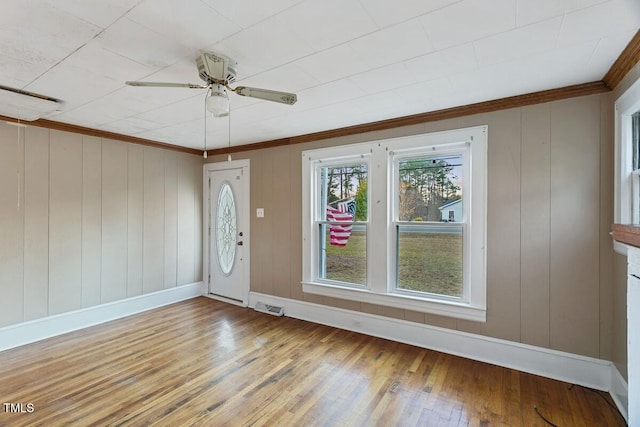 foyer featuring ceiling fan, wood-type flooring, and crown molding