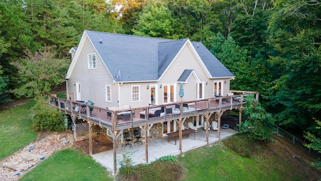 rear view of property with a patio area, a yard, and a wooden deck