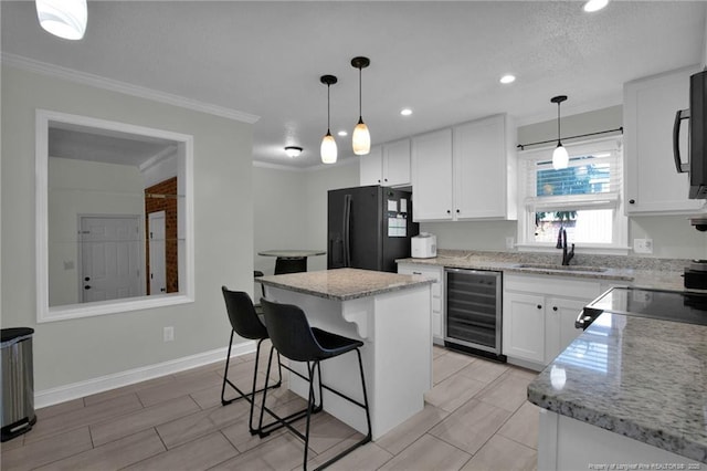 kitchen with a center island, black refrigerator with ice dispenser, white cabinets, sink, and wine cooler