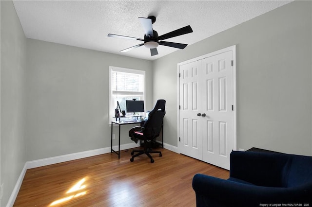 office space featuring wood-type flooring, a textured ceiling, and ceiling fan