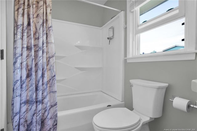 bathroom featuring shower / bath combo and toilet