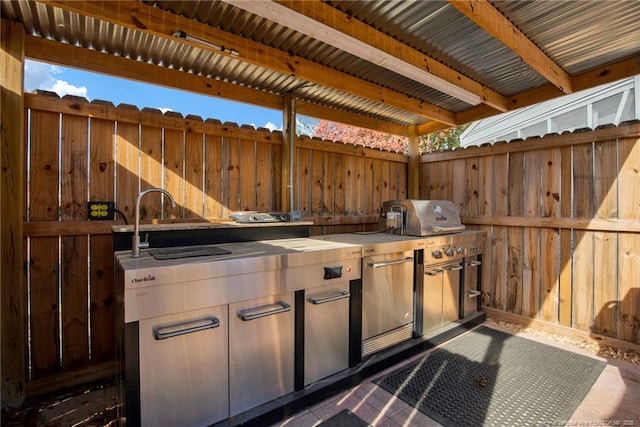 view of patio featuring sink and an outdoor kitchen