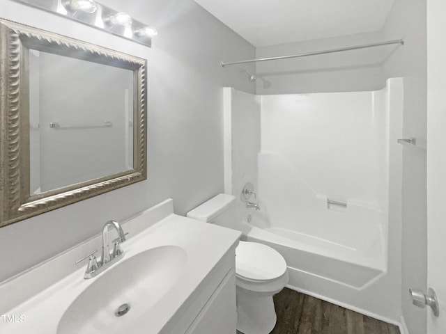 full bathroom with vanity, toilet, wood-type flooring, and shower / washtub combination