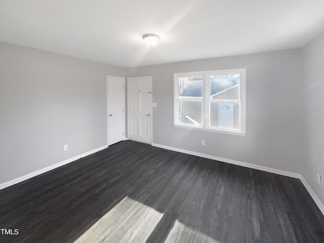 spare room featuring dark hardwood / wood-style flooring