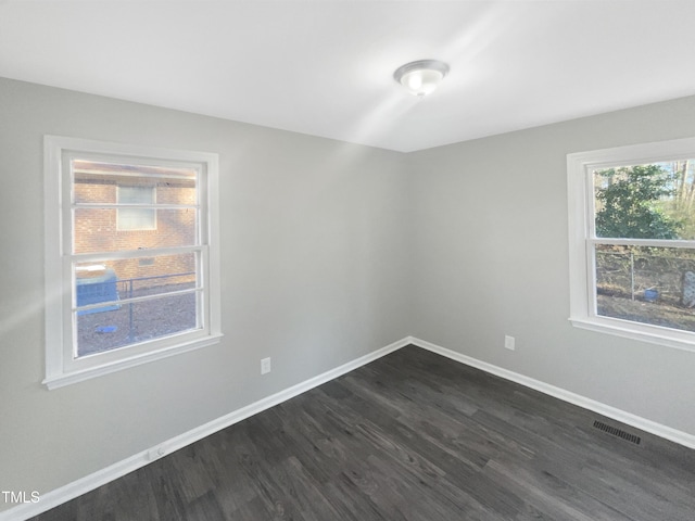 unfurnished room featuring dark wood-type flooring