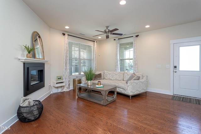 living room with dark hardwood / wood-style floors and ceiling fan