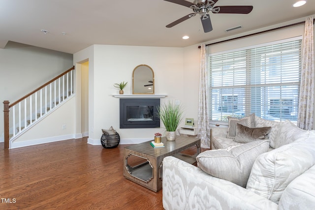 living room featuring hardwood / wood-style flooring and ceiling fan