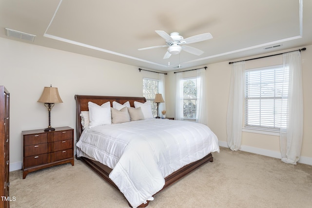 carpeted bedroom with multiple windows and ceiling fan