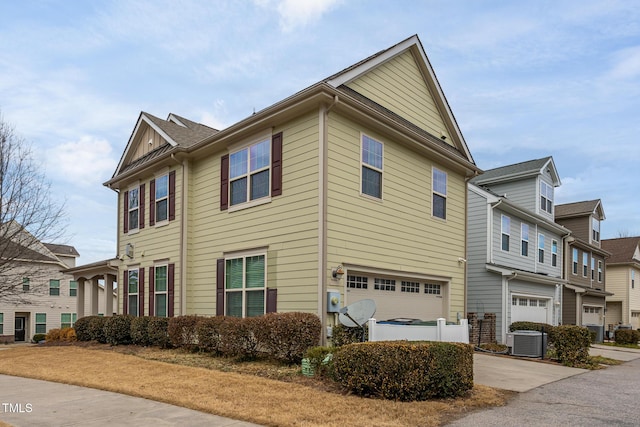 view of home's exterior with cooling unit and a garage