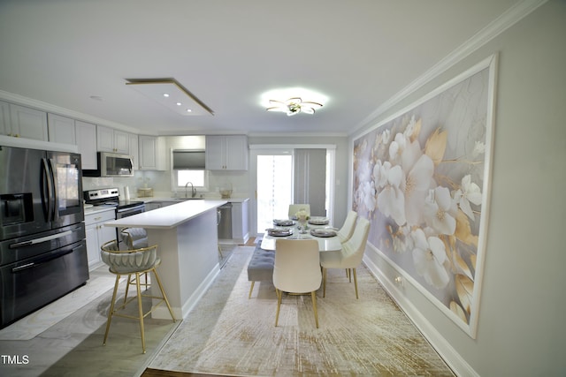 kitchen featuring a center island, crown molding, sink, tasteful backsplash, and stainless steel appliances