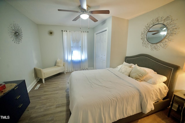 bedroom with ceiling fan, dark hardwood / wood-style floors, and a closet