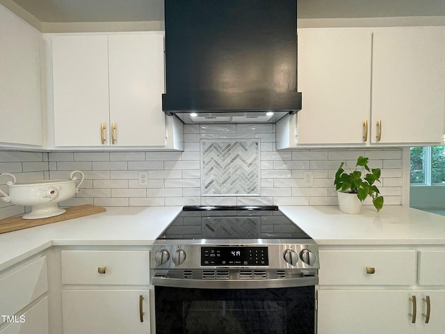 kitchen with white cabinetry, backsplash, stainless steel electric range oven, and extractor fan