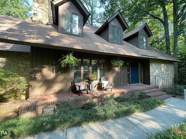 back of house featuring a porch