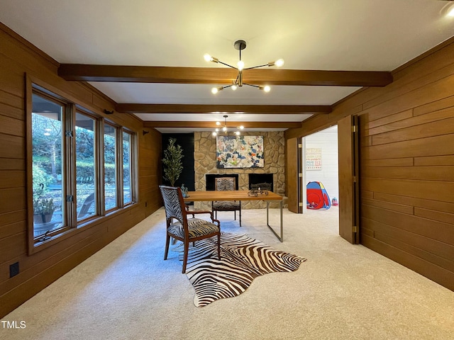 dining room with beamed ceiling, carpet, wood walls, and a notable chandelier