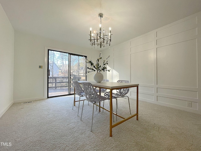 dining room featuring carpet floors and a notable chandelier