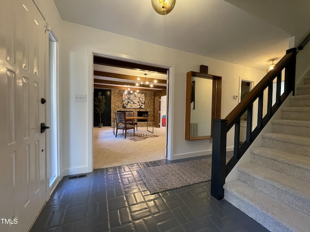 foyer with a stone fireplace