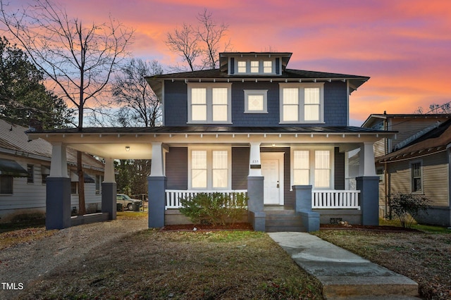 view of front of house with a porch and a yard