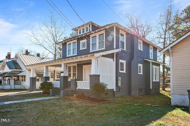 view of front of property with covered porch and a front yard