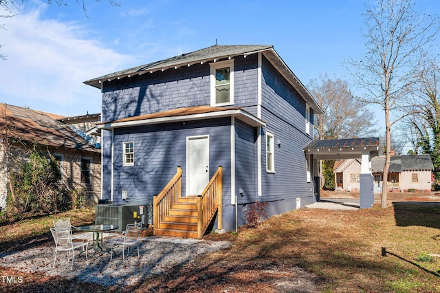 back of property featuring cooling unit