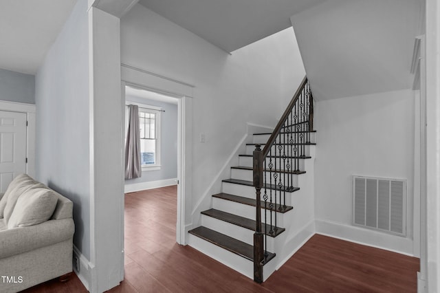 staircase featuring wood-type flooring