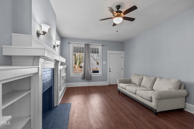 living room with ceiling fan and dark hardwood / wood-style flooring