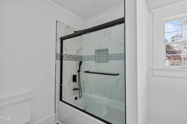 bathroom featuring toilet, ornamental molding, and bath / shower combo with glass door