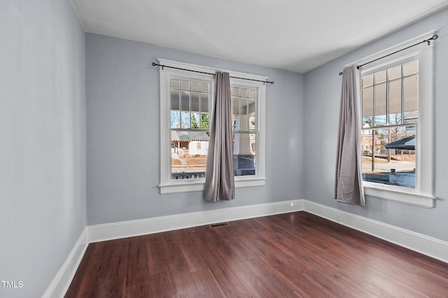 empty room with dark wood-type flooring