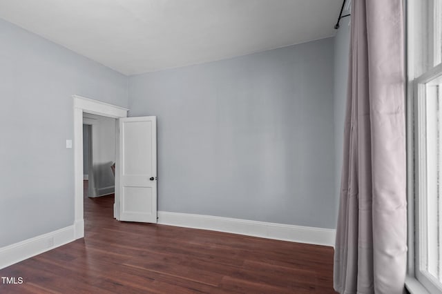 unfurnished room featuring dark hardwood / wood-style floors