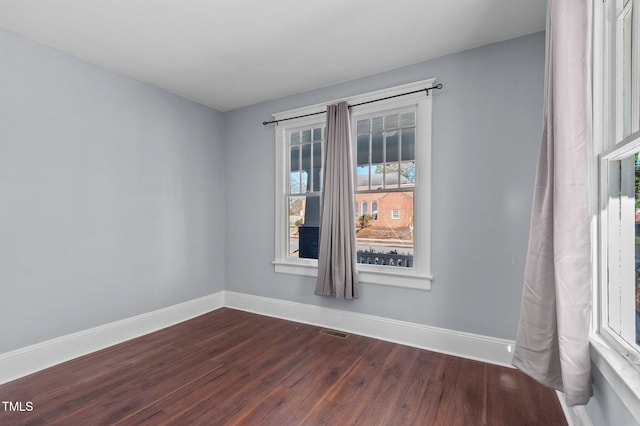 spare room with hardwood / wood-style floors