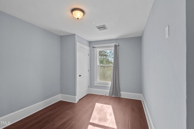 spare room with hardwood / wood-style flooring