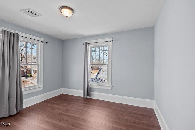 empty room with dark hardwood / wood-style floors