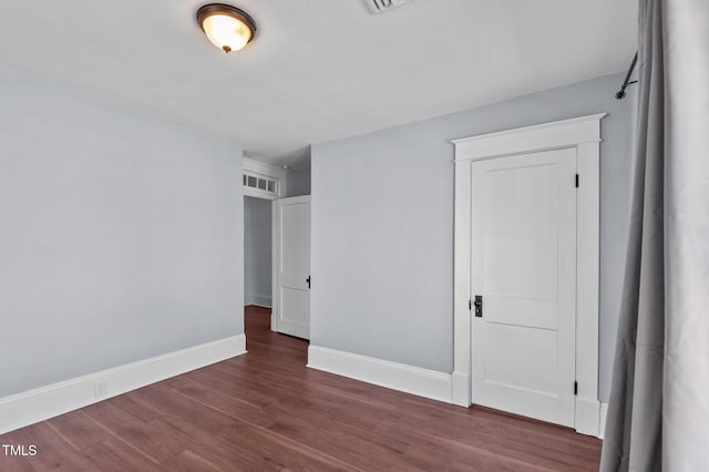 unfurnished bedroom featuring dark hardwood / wood-style floors