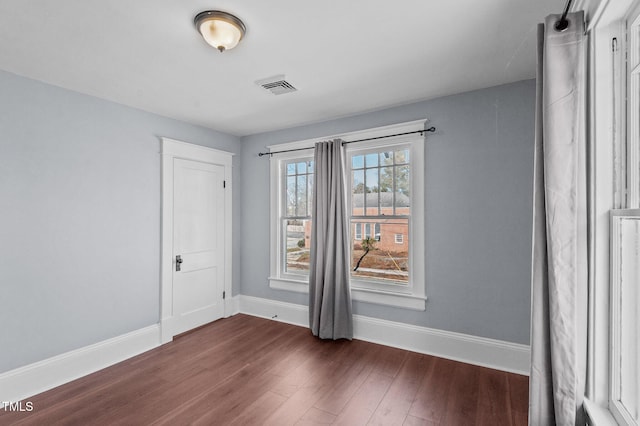 unfurnished room with dark hardwood / wood-style floors