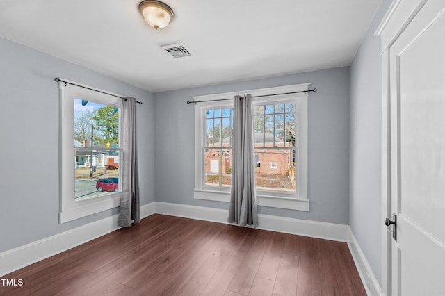 empty room with dark hardwood / wood-style floors