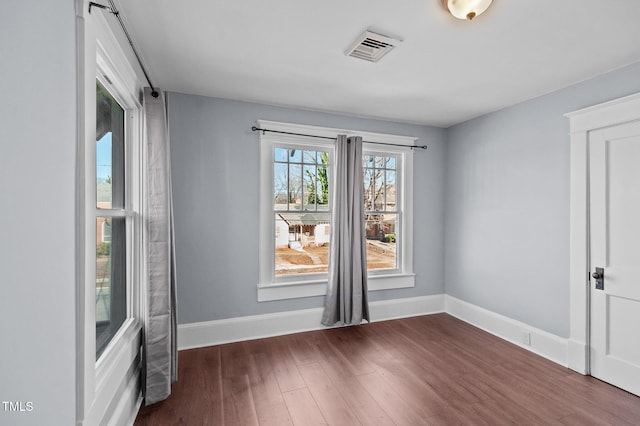 spare room featuring dark hardwood / wood-style flooring