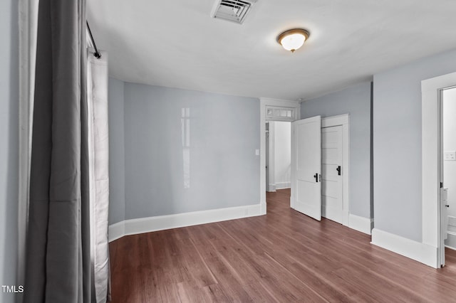 unfurnished bedroom featuring hardwood / wood-style flooring