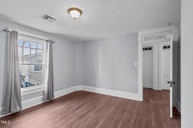 unfurnished room featuring dark hardwood / wood-style flooring