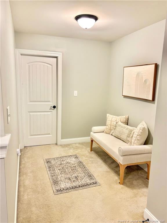 sitting room featuring light colored carpet