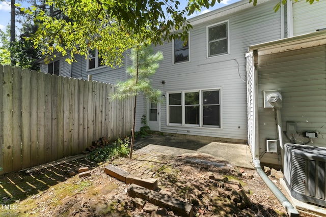 back of house with central AC and a patio area