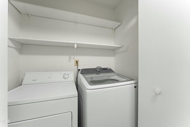 laundry area featuring washing machine and clothes dryer