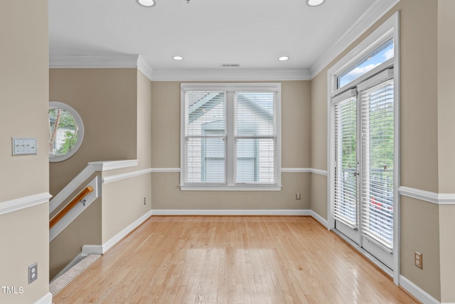 unfurnished room with light hardwood / wood-style floors and ornamental molding