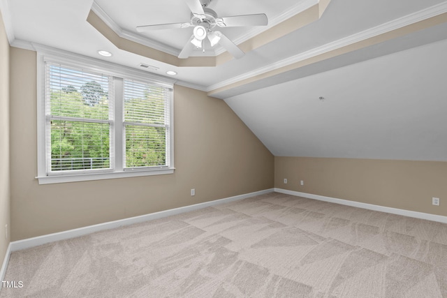 additional living space featuring light colored carpet, plenty of natural light, and ceiling fan