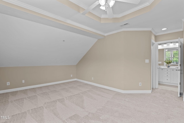 additional living space with light colored carpet and ceiling fan