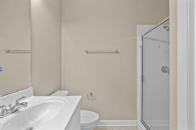 bathroom with tile patterned flooring, vanity, an enclosed shower, and toilet