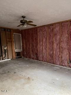 misc room with ceiling fan and concrete floors